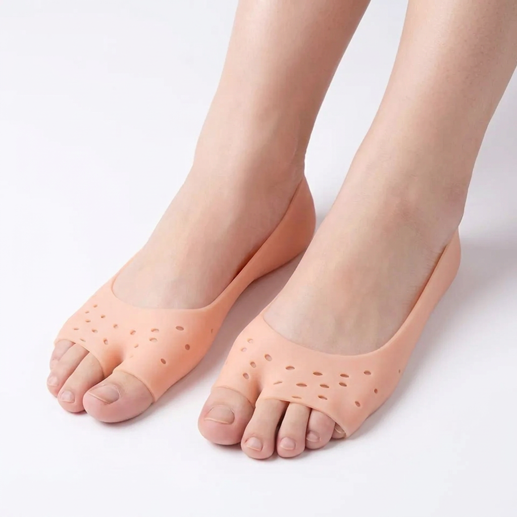 Adult feet wearing peach open-toe silicone foot covers against a white background