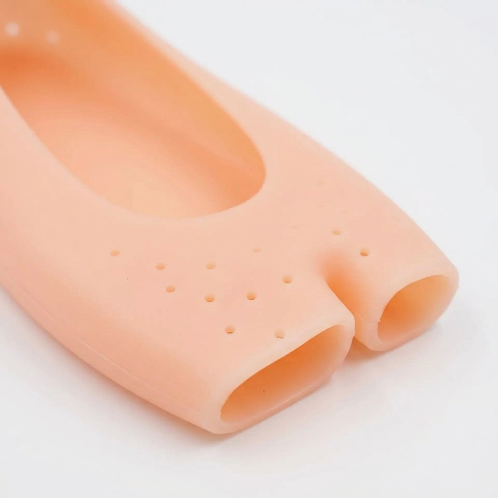 Close-up of the forefoot perforations and divided toe edge of a peach silicone foot cover