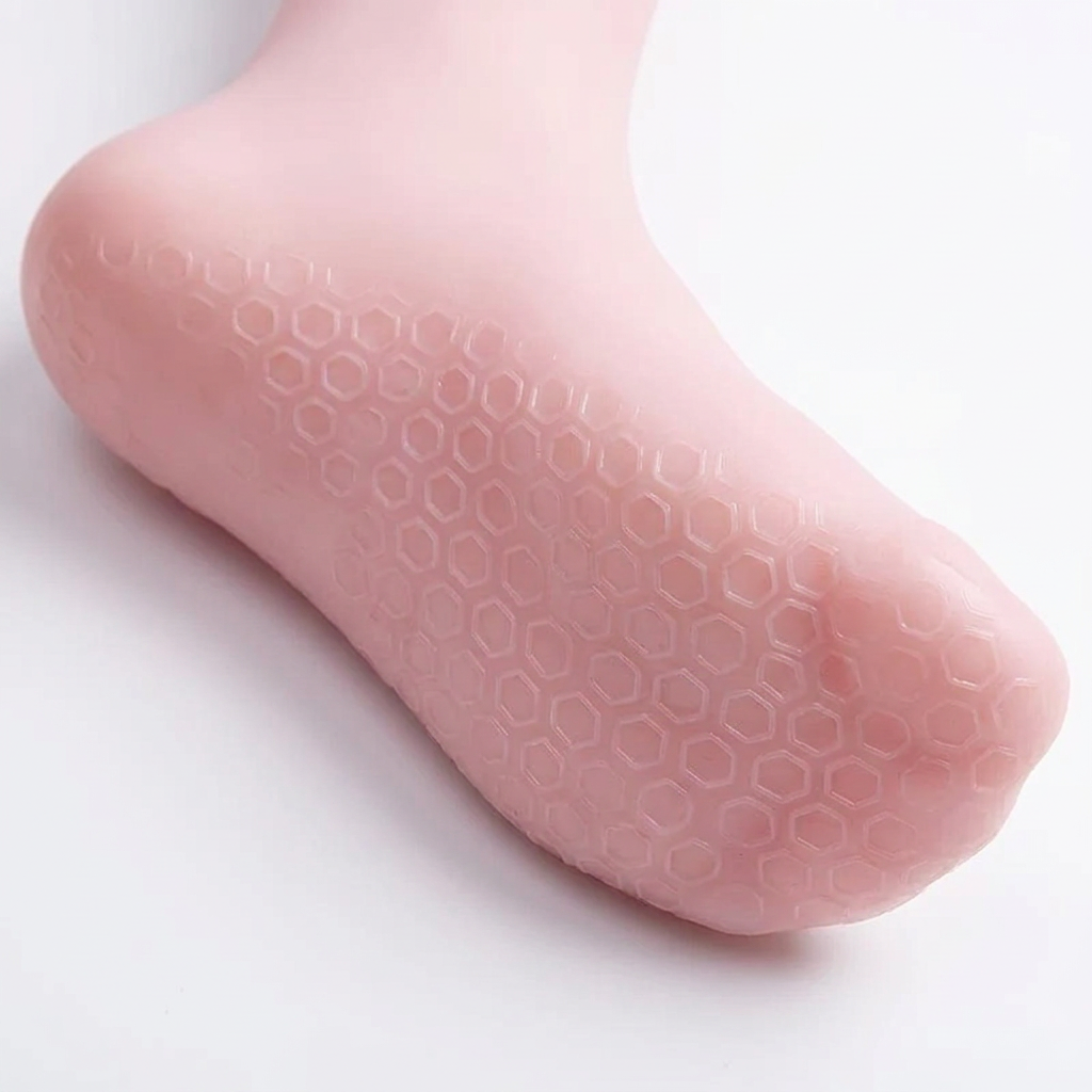 Close-up of the honeycomb-style sole texture on a pink gel foot-care sock