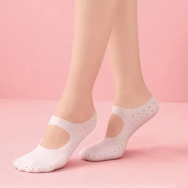 Feet wearing translucent white closed-toe gel foot covers against a pink background