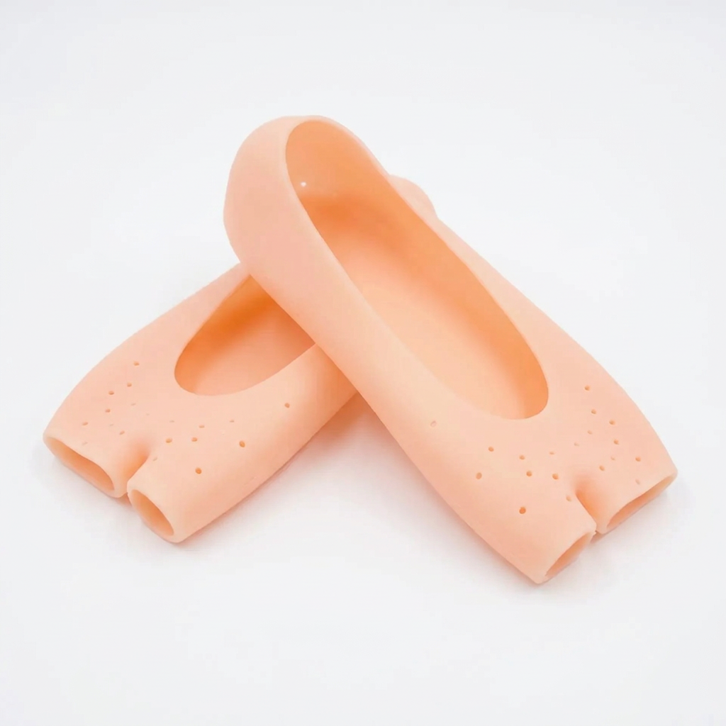 Pair of peach open-toe silicone foot covers on a white background