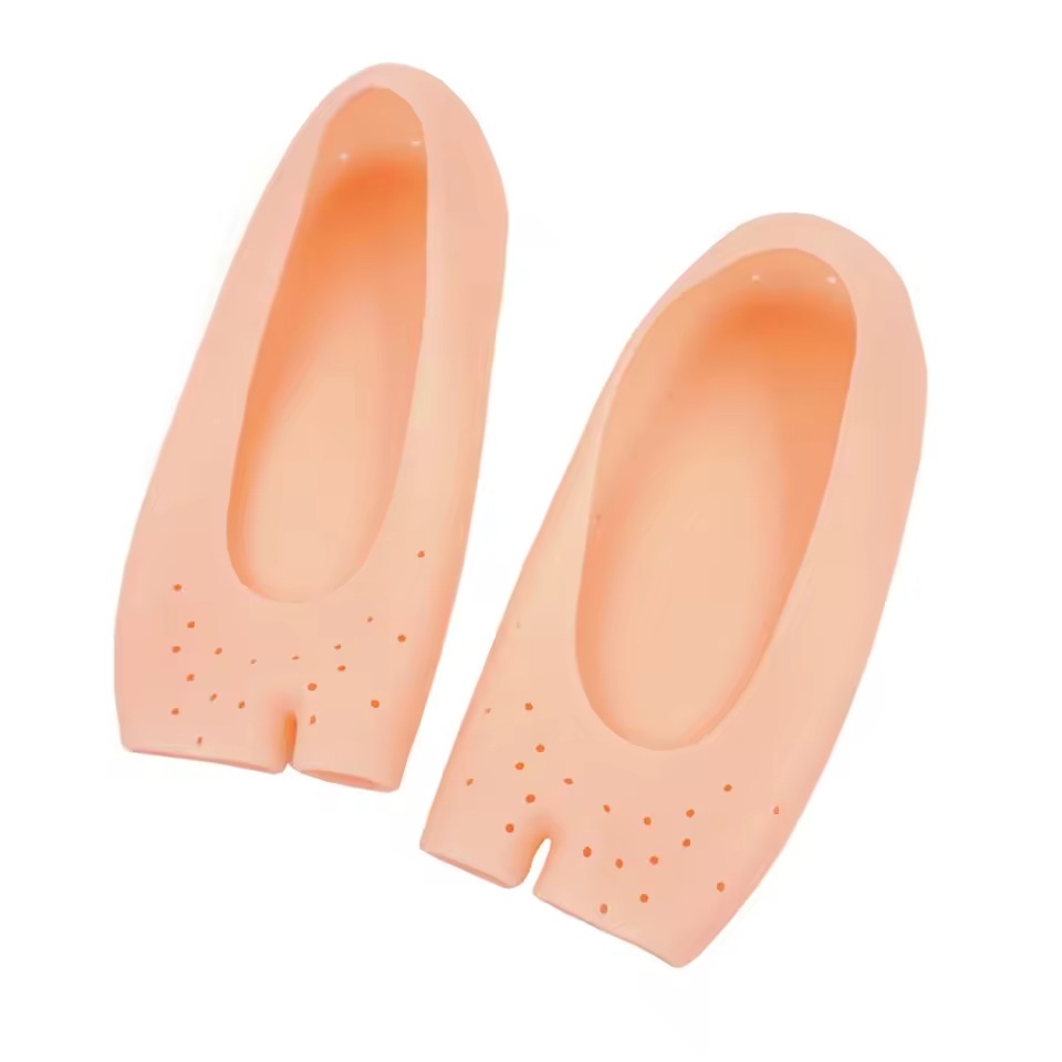 Pair of peach open-toe silicone foot covers with forefoot perforations on a white background
